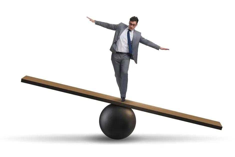 Balancing Businessman on Seesaw